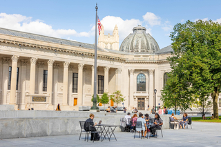 Sweeping view of hewitt quadrangle with people sitting at tables